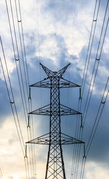 Silhouette view of electricity post in the evening with blue sky.