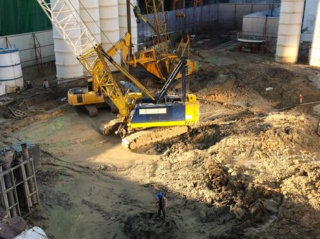 Construction site with crane and worker in progress.