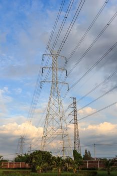 Electricity post in the evening with blue sky and the land.