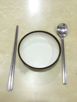 Chopsticks and dish and spoon. Korean style.