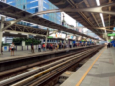 Blurred people waiting for sky train in Bangkok.