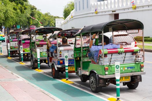 Bangkok, Thailand August 2: Thai TukTuk taxi parking in the row beside the grand palace on August 2, 2015 in Bangkok, Thailand.