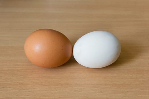 Duck egg and Chicken egg on the wooden table