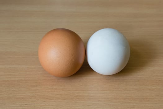 Duck egg and Chicken egg on the wooden table