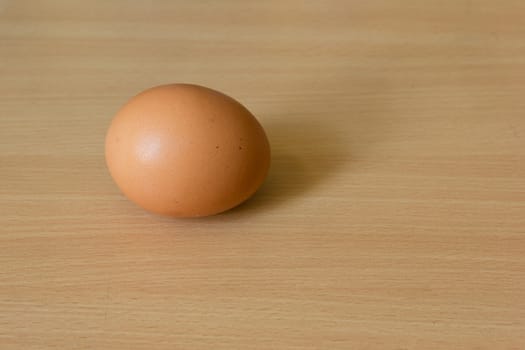 Chicken egg on the wooden table