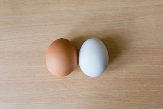 Duck egg and Chicken egg on the wooden table