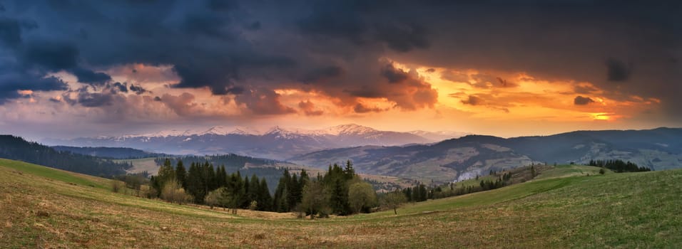 April storm and sunset in Carpathian mountains. Spring evening