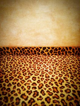 Retro background. Leopard carpet and grungy old wall.