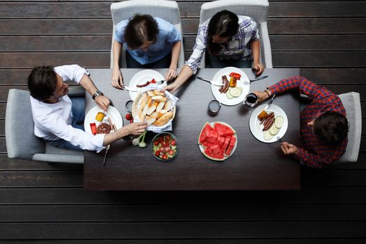 Four friends having dinner, top view
