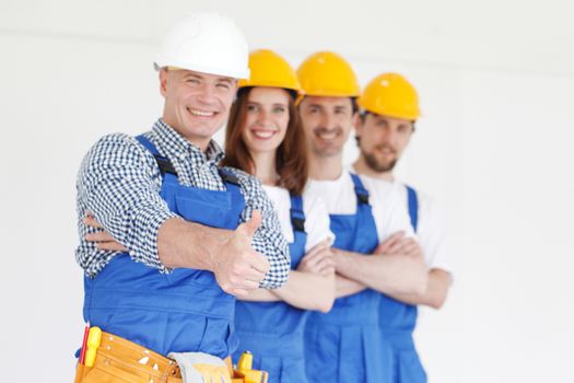 Team of happy workers in uniform ready to work