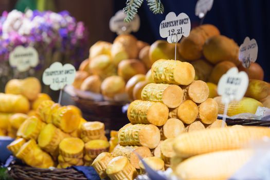 Traditional Polish smoked cheese (Oscypek) on a Christmas market stand in Krakow, Poland.