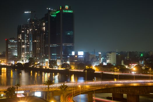 Cairo, Egypt - October 29, 2014: Traffic light trails in Cairo at night, the 15th May bridge, the Nile river and the Corniche Street.