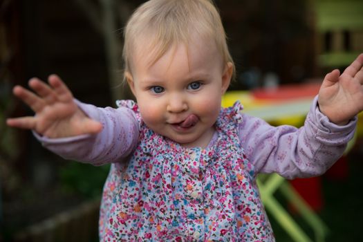 Young blond girl learning to walk