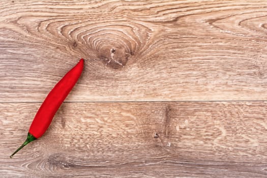 Fresh red chilli on old wood background