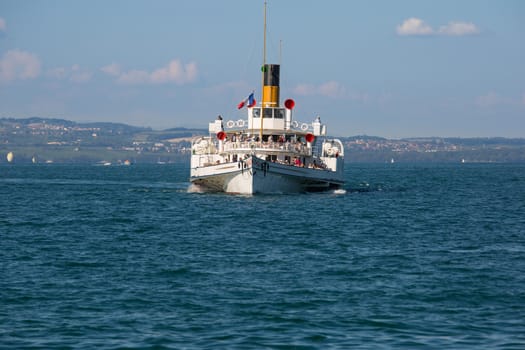 Yvoire, France - August 22, 2015: The Simplon passenger steamboat arriving in the medieval city of Yvoire, France.