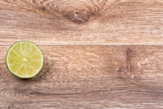 Fresh limes on a wooden background