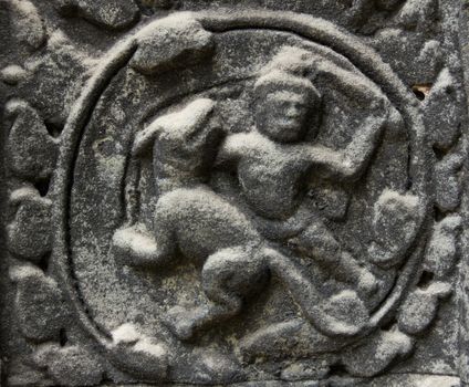 Bas-Relief at Ta Phrom temple showing a fighting scene between a men and a dog