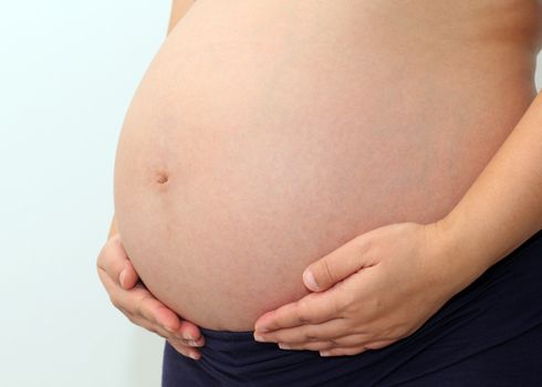 Photo of a cute pregnant woman belly