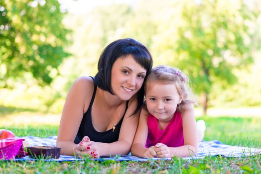 happy incomplete family at a picnic in the park