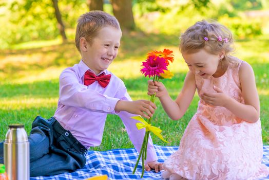 the little gentleman gives the girl a bunch of flowers