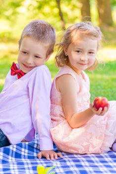 Girl with peach and a little gentleman at the picnic