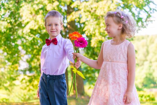 Groom gives a little girl a bouquet of flowers