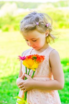 Portrait of a girl of 6 years with a bouquet of gerberas