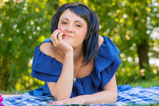 Portrait of a young and beautiful woman on a sunny day in the park