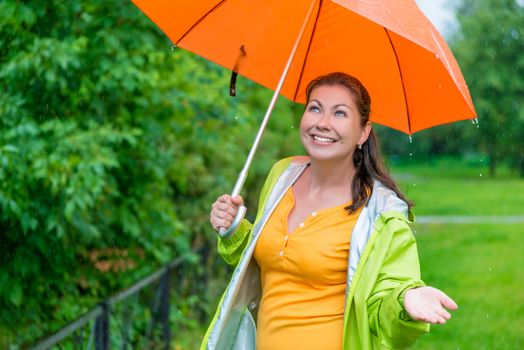 beautiful girl with a bright orange umbrella