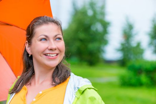 Horizontal photo portrait of a woman with an umbrella outdoors