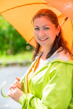 close-up portrait of a girl with an orange umbrella