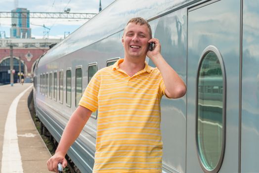 man talking on the phone in train station