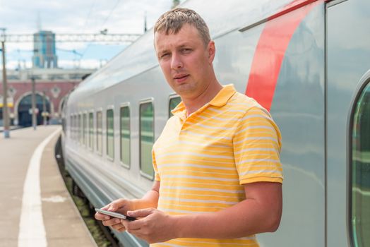 man in a yellow shirt at the railway station