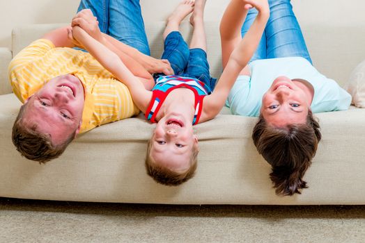 happy family with a child on a sofa in the living room