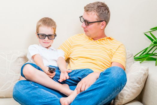 Family in 3D glasses in the living room watching television