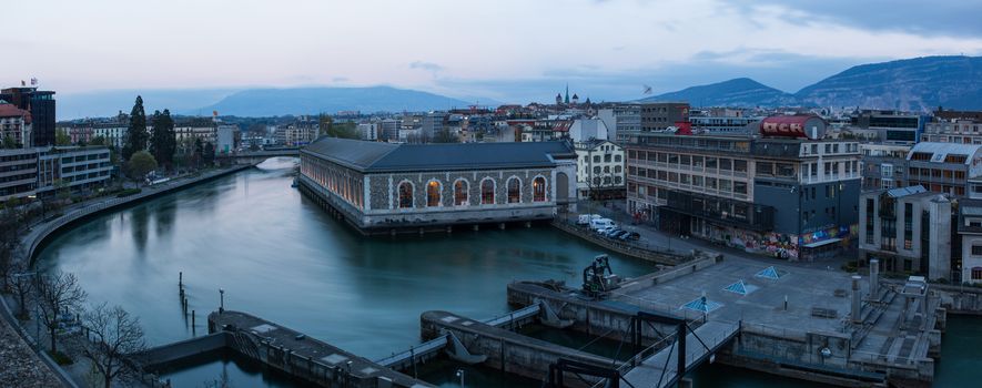 Panoramic of Geneva at dusk. The Seujet dam, the Rhone river and the city.