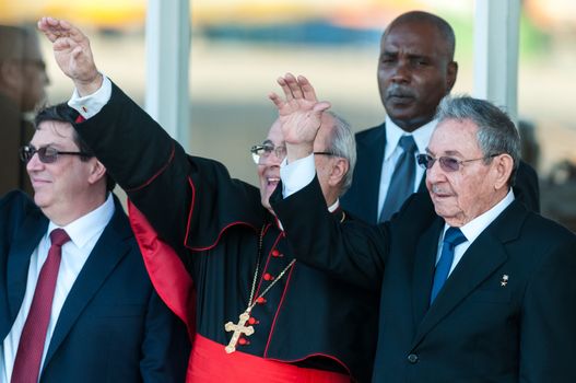 CUBA, Havana: Cuban President Raul Castro (R) and Cuban Cardinal Jaime Ortega (C) wave to Pope Francis at Jose Marti International Airport in Havana as he leaves for Mexico on February 12, 2016. Pope Francis and Russian Orthodox Patriarch Kirill kissed each other and sat down together Friday at Havana airport for the first meeting between their two branches of the church in nearly a thousand years.