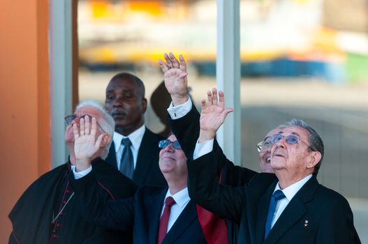 CUBA, Havana: Cuban President Raul Castro (R) and Cuban Cardinal Jaime Ortega (C) wave to Pope Francis at Jose Marti International Airport in Havana as he leaves for Mexico on February 12, 2016. Pope Francis and Russian Orthodox Patriarch Kirill kissed each other and sat down together Friday at Havana airport for the first meeting between their two branches of the church in nearly a thousand years.