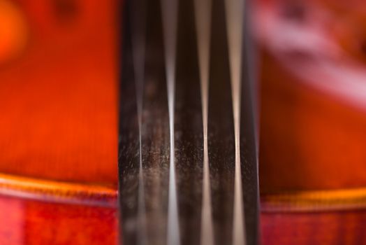 A close up shot of the details of a violin.