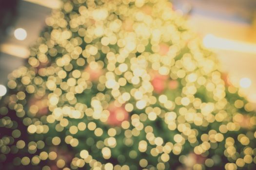 Gold Christmas background of de-focused lights with decorated tree, Christmas background 