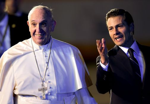 MEXICO, Mexico City: Pope Francis (C) walks next to Mexican President Enrique Pena Nieto (R) upon his arrival at Benito Juarez international airport in Mexico City on February 12, 2016. Catholic faithful flocked to the streets of Mexico City to greet Pope Francis on Friday after the pontiff held a historic meeting with the head of the Russian Orthodox Church in Cuba.
