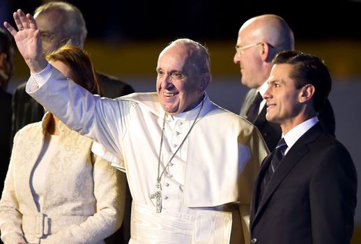 MEXICO, Mexico City: Pope Francis (C) walks next to Mexican President Enrique Pena Nieto (R) upon his arrival at Benito Juarez international airport in Mexico City on February 12, 2016. Catholic faithful flocked to the streets of Mexico City to greet Pope Francis on Friday after the pontiff held a historic meeting with the head of the Russian Orthodox Church in Cuba.