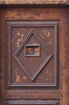 Detail of a wooden door with square and diamond pattern