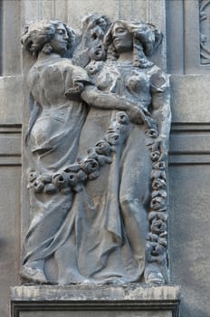 Woman statue on the wall. Architecture detail. Stone sculpture. Parged with plaster