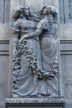 Woman statue on the wall. Architecture detail. Stone sculpture. Parged with plaster