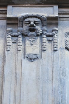 Man face on the wall. Architecture detail. Stone sculpture. Parged with plaster
