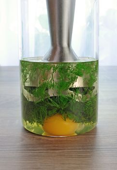 olive oil, egg yolk, dill in a glass with immersion blender to prepare a creamy sauce