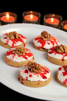 Cookies in white glaze drip blood and walnuts