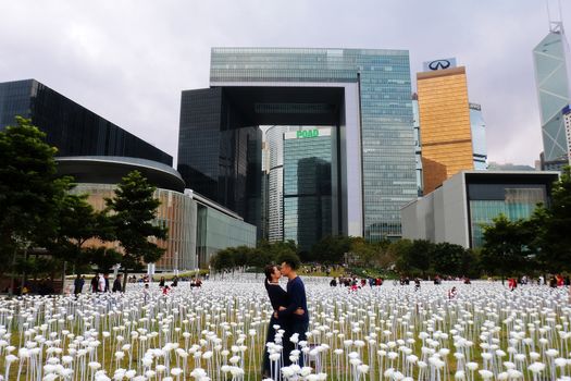 HONG KONG: People kiss in the middle of white LED roses on display in Hong Kong on February 13, 2016 for Valentine's Day.