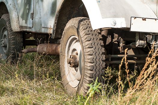 Gray and olive vintage military truck on the road